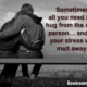 A monochrome image showing a young couple sitting on a bench, embracing tightly with dark red typography. A comforting and romantic quote about the soothing power of love and affection