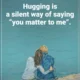 An affectionate quote reading 'Hugging is a silent way of saying 'you matter to me'.' in bold white sans-serif text over an artistic illustration of two people sitting together at the edge of calm teal water. A heartwarming quote about affection, connection, and expressing love and care through physical comfort and embrace
