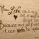 A handwritten quote about true love written in dark brown cursive ink on lined paper with a small drawn heart. romantic handwritten quote emphasizing the value of true love and the commitment needed to cherish and protect it